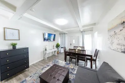 a living room with a couch and a table at 8 Beds Home with 4 Car Parking Space - Near DTLB in Long Beach