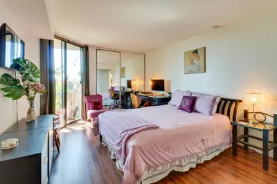 a bedroom with a bed and a desk and a room at Granada Hills Condo with Community Pool and Workspace in Los Angeles