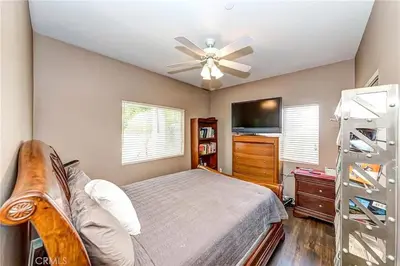 a bedroom with a bed and a ceiling fan at Redondo Beach Suite, 2 BR 1st floor Surf Gym workspace in Redondo Beach