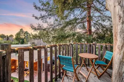 two chairs and a table on a deck at Modern Family Farmhouse with Pool, Jacuzzi, Putting Green, Treehouse, Bocce and more in Thousand Oaks