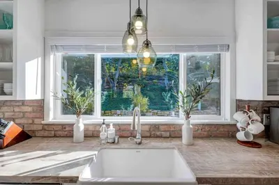 a kitchen counter with a sink and a window at Modern Family Farmhouse with Pool, Jacuzzi, Putting Green, Treehouse, Bocce and more in Thousand Oaks
