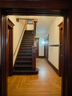an empty hallway with stairs in an old house at Lovely Home at Westminster in Westminster