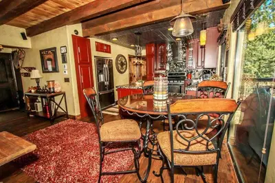 a kitchen with a table and chairs in a room at How Sweet It Is~ Downtown Village Retreat Cabin~ Walk to Marinas and Shopping in Big Bear Lake