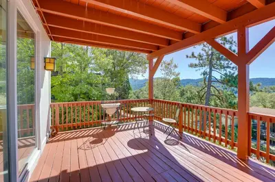 a large deck with a view of the mountains at Lake Arrowhead Home with 3 Decks and Stunning Views! in Lake Arrowhead