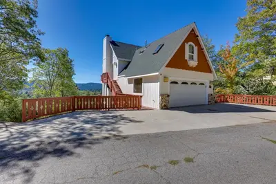 a house with a wooden fence and a driveway at Lake Arrowhead Home with 3 Decks and Stunning Views! in Lake Arrowhead