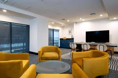 a room with chairs and a table and a tv at Kasa Sunset Los Angeles in Los Angeles