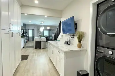 a kitchen with white cabinets and a microwave at LA Home - FIFA Soccer, NBA Games, Universal Studios in Los Angeles