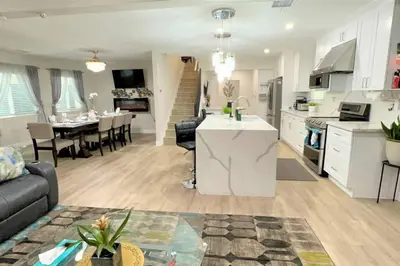 a kitchen and living room with a couch and a table at LA Home - FIFA Soccer, NBA Games, Universal Studios in Los Angeles