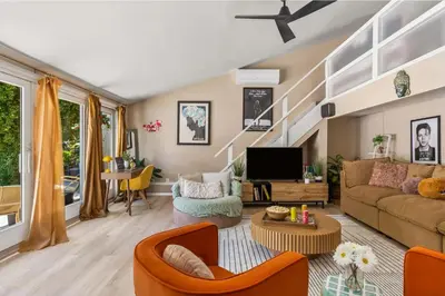 a living room with a couch and a tv at The Malibu Retreat Guest House - Salt Water Pool & Jacuzzi, Nature Oasis in Calabasas