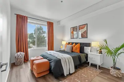 a bedroom with a bed and an orange chair at Luxury 2BDR with Parking & Pool - Marina del Rey in Los Angeles