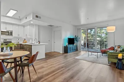 a kitchen and living room with a table and a couch at Luxury 2BDR with Parking & Pool - Marina del Rey in Los Angeles