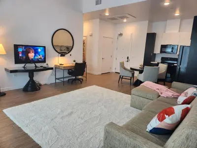 a living room with a couch and a table with a mirror at Art District Downtown Spacious Homes in Los Angeles