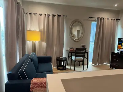 a living room with a blue couch and a table at Art District Downtown Spacious Homes in Los Angeles