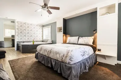 a bedroom with a large bed and a bath tub at Big Bear Spa Suites in Big Bear Lake