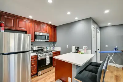 a kitchen with wooden cabinets and a stainless steel refrigerator at Hidden Gem in Hawthorne about 3 Mi to SoFi Stadium in Hawthorne