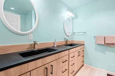 a bathroom with a sink and a mirror at Paramount Paradise in Big Bear Lake