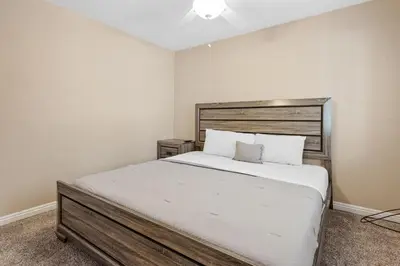 a bedroom with a large bed with a wooden headboard at Paramount Paradise in Big Bear Lake