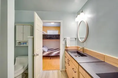 a bathroom with a sink and a toilet and a mirror at Paramount Paradise in Big Bear Lake