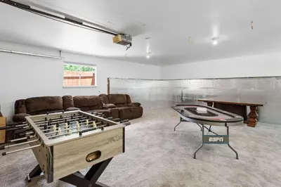 a living room with a couch and a table with a chessboard at Paramount Paradise in Big Bear Lake