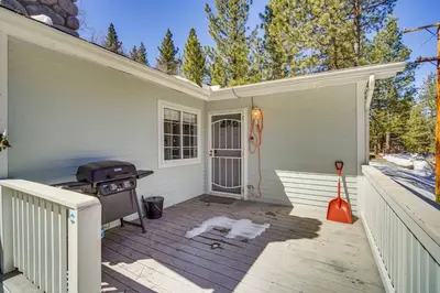 a dog laying on a patio with a grill at Paramount Paradise in Big Bear Lake