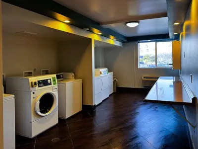 a laundry room with a washer and dryer at Studio 6 Suites Carson, CA in Carson