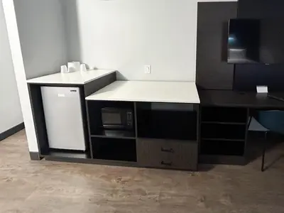 a kitchen with a counter with a sink and a microwave at Studio 6 Suites Carson, CA in Carson