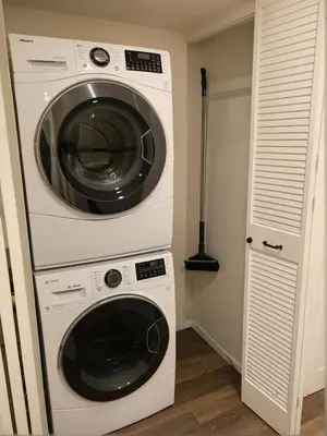 a washing machine and a dryer in a room at Glamorous KTown Boutique Residences with Rooftop view in Los Angeles