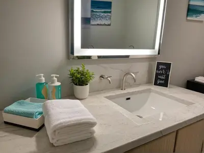 a bathroom with a sink and a mirror at Glamorous KTown Boutique Residences with Rooftop view in Los Angeles