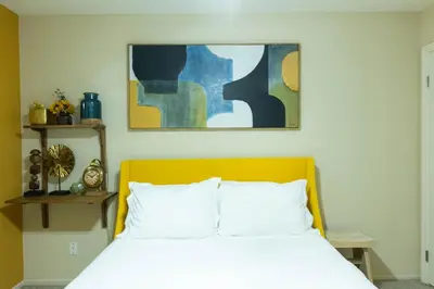 a bedroom with a bed and a painting on the wall at Lovely and cozy apartment- Rancho in Rancho Palos Verdes