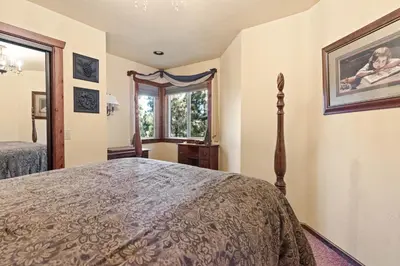 a bedroom with a bed and a window at Big Bear Villa - Walk to Lake ad Village! Hot Tub, Jet Tub and so much more! in Big Bear Lake