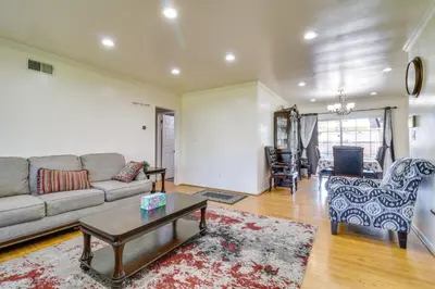a living room with a couch and a table at North Hills Home with Outdoor Entertaining Space in North Hills