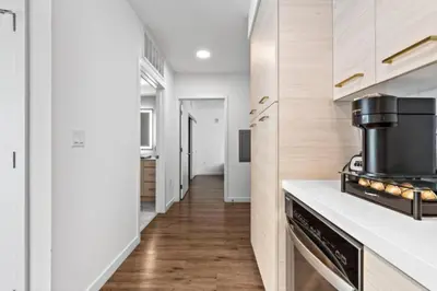 a kitchen with white cabinets and a stove at Amber Drift - Santa Monica 2BR Penthouse Ocean views in Los Angeles