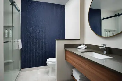 a bathroom with a sink and a mirror and a toilet at Fairfield by Marriott Inn & Suites Barstow in Barstow