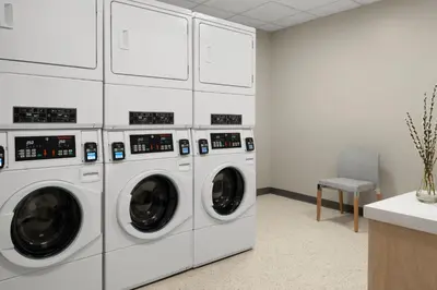 a row of white washing machines in a room at Fairfield by Marriott Inn & Suites Barstow in Barstow