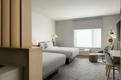 a hotel room with two beds and a desk at TownePlace Suites by Marriott Marriott Barstow in Barstow