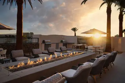 a fire pit on a patio with chairs and tables at TownePlace Suites by Marriott Marriott Barstow in Barstow