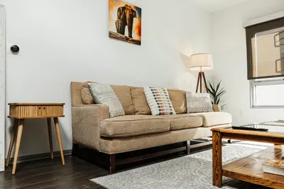a living room with a couch and a table at Oasis in heart of Hollywood in Los Angeles