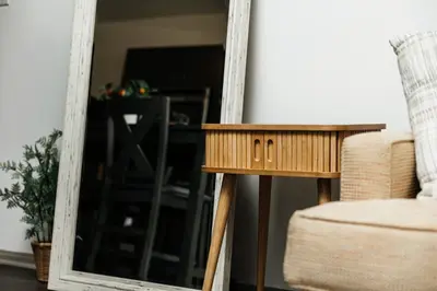 a mirror next to a table and a chair at Oasis in heart of Hollywood in Los Angeles