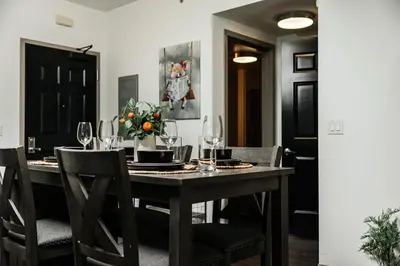 a dining room with a table with wine glasses at Oasis in heart of Hollywood in Los Angeles