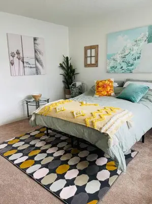 a bedroom with a large bed and a rug at Spacious Studio close to LAX and close to beaches! in Gardena