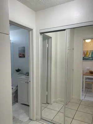 a bathroom with a toilet and a glass door at Spacious Studio close to LAX and close to beaches! in Gardena