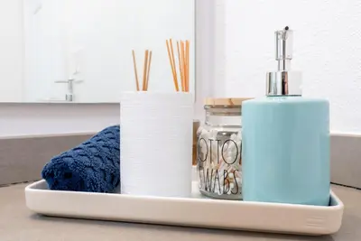 a tray with towels and a bottle of soap at Cozy Huge LOFT for Live and Work in Los Angeles