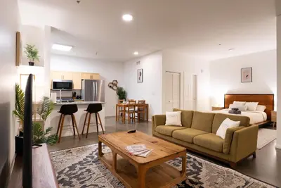 a living room with a couch and a table at Huge luxury loft for enjoying in Los Angeles