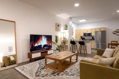 a living room with a couch and a tv and a table at Huge luxury loft for enjoying in Los Angeles