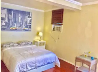a bedroom with a bed and a painting on the wall at Echo Park Studio Oasis with Modern Comforts in Los Angeles