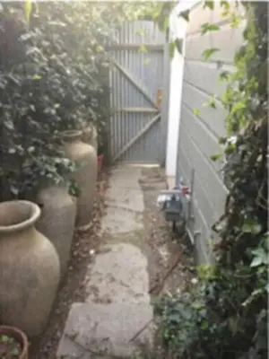a small alley with a gate and some plants at Echo Park Studio Oasis with Modern Comforts in Los Angeles
