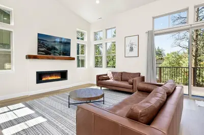 a living room with a couch and a fireplace at The Pines Retreat- Impeccable Modern Village Chalet in Big Bear Lake