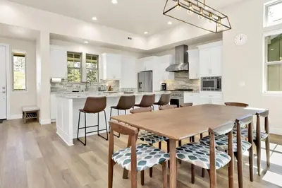 a kitchen with a wooden table and chairs at The Pines Retreat- Impeccable Modern Village Chalet in Big Bear Lake