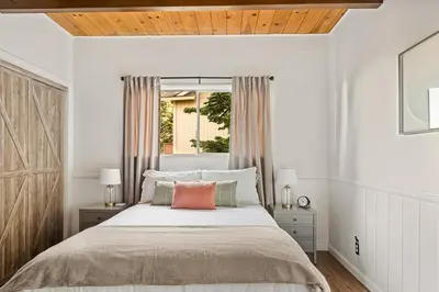 a bedroom with a bed and a window at Romantic & Family Friendly Chalet In The Woods in Lake Arrowhead