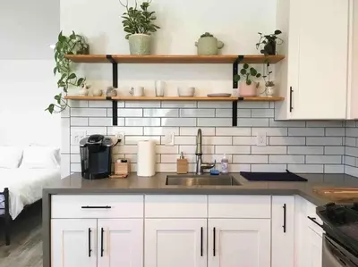 a kitchen with white cabinets and a sink at The Cozy Oasis - A Renovated and Modern Studio near LAX + SoFi + Beaches + Freeway in Lawndale